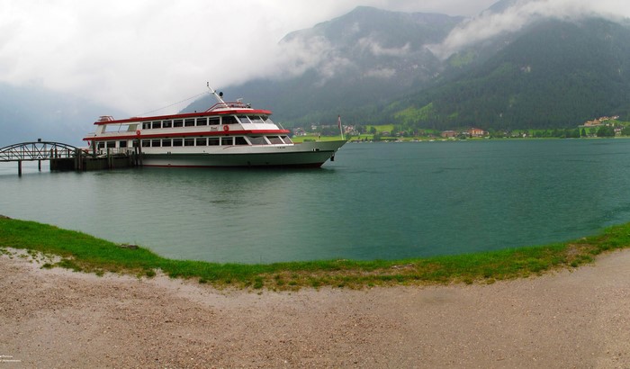 Passenger ship docked at a pier on a lake in Austria