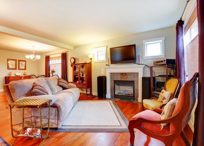 Living room with sofa, fireplace, and dining area