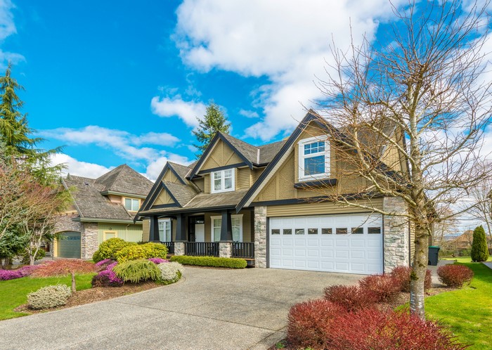 Suburban houses with manicured lawns and trees