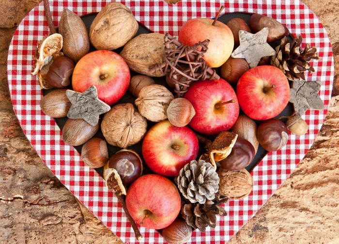 Apples and nuts arranged in a heart shape