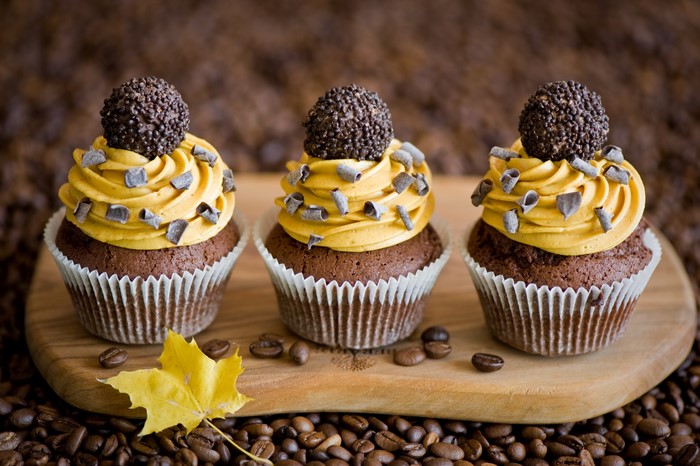 Three chocolate cupcakes with coffee frosting and chocolate balls
