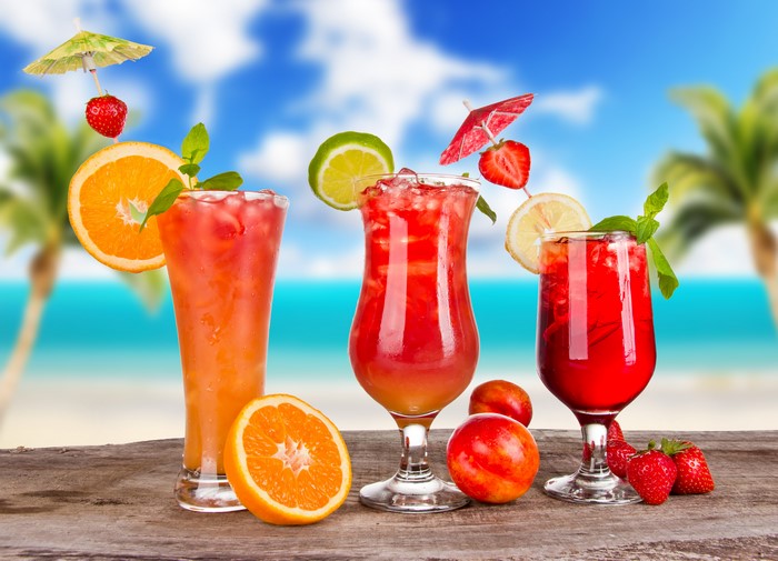 Tropical Cocktails with Fruit on a Beach Background
