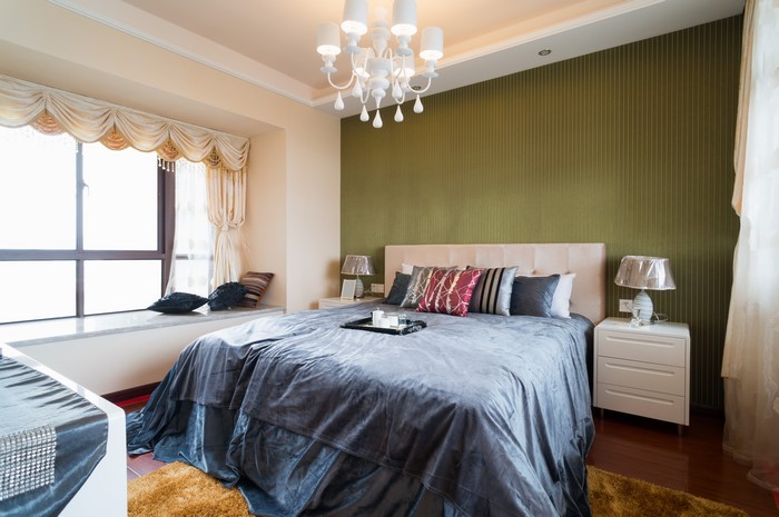 Bedroom Interior with Bed, Pillows, Lamp, and Chandelier