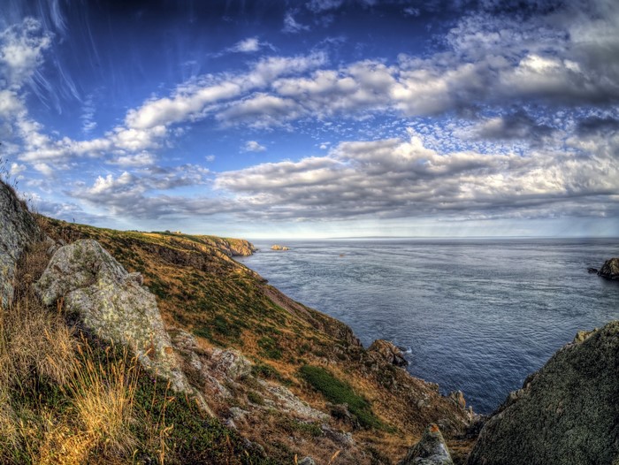 Rocky Coastline with Ocean and Cloudy Sky