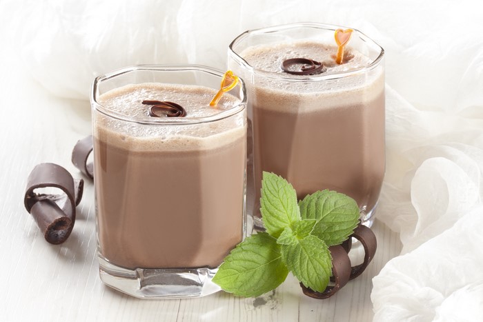Two chocolate drinks with mint and chocolate curls
