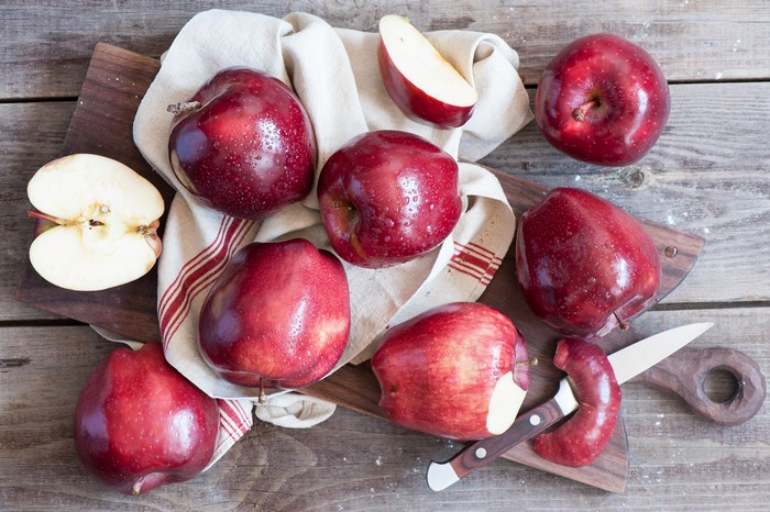 Red Apples on Wooden Table with Knife