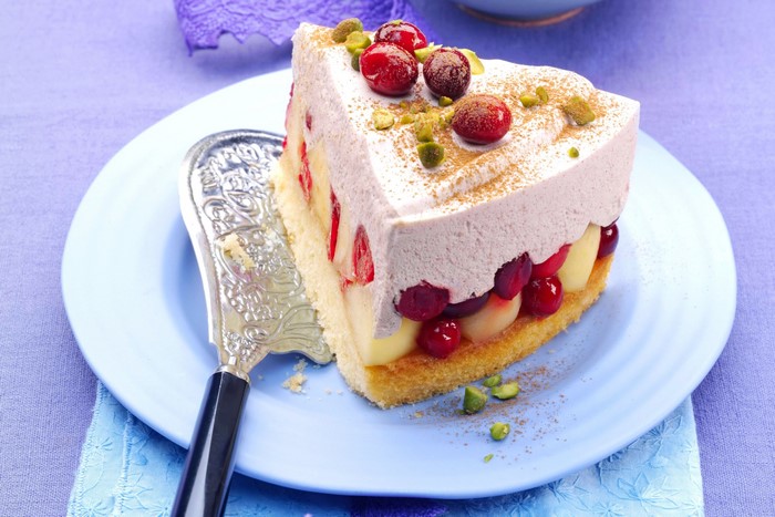 Slice of fruit cake with cream and pistachios