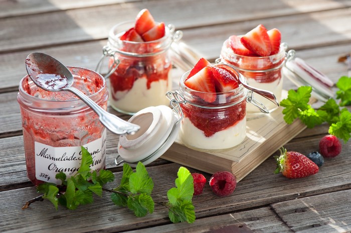 Desserts in jars with strawberries and raspberries