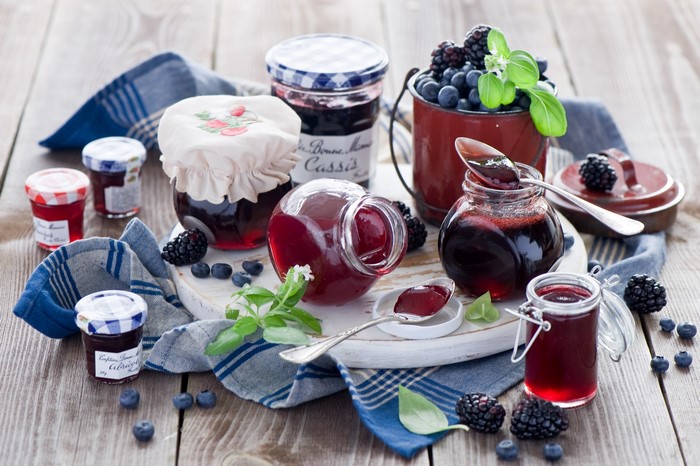 Jars of jam with blackberries and blueberries
