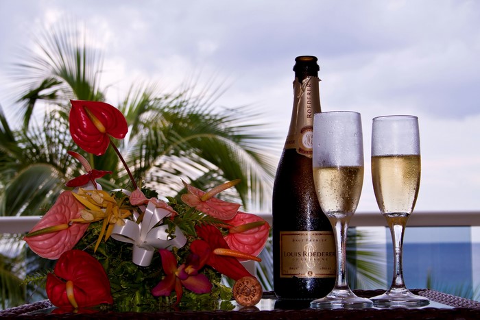 Champagne bottle and glasses with flowers