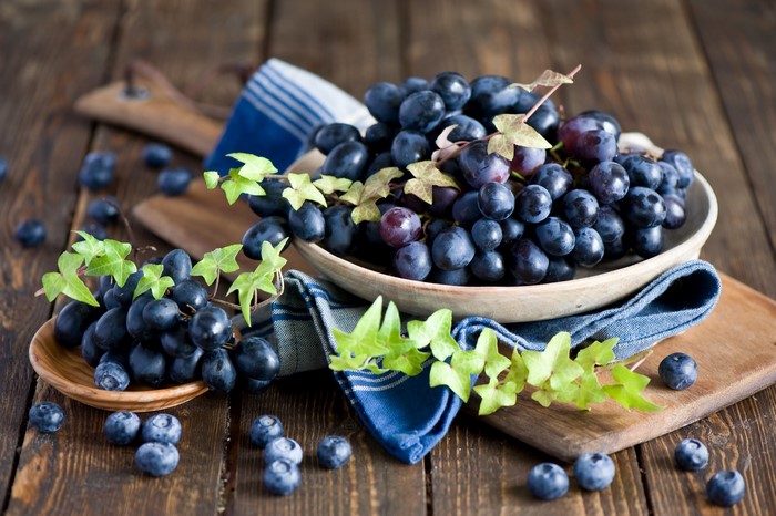 Grapes and Blueberries on Wooden Table