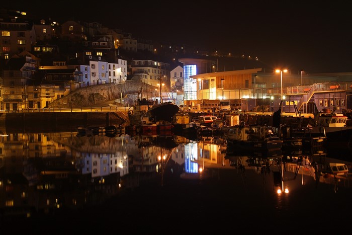 Brixham harbor at night with reflections