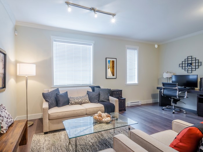 Living room with sofa, coffee table, and desk
