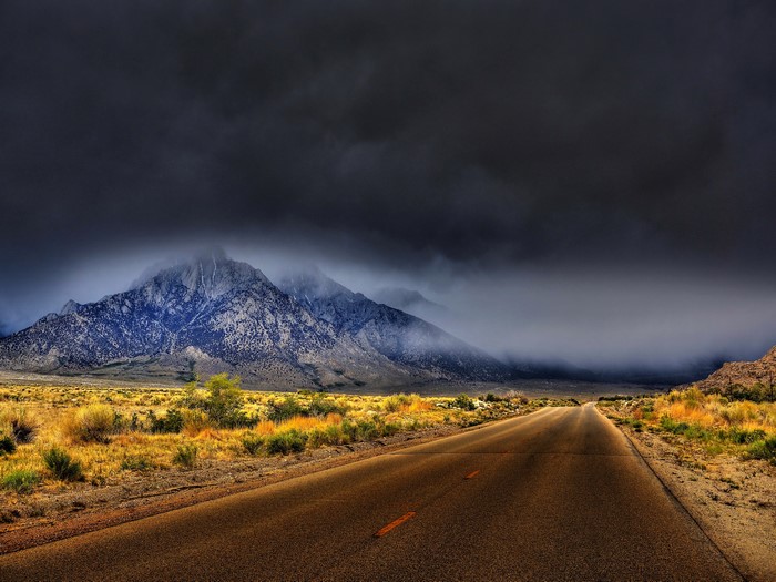 Road leading to misty mountains in California, USA