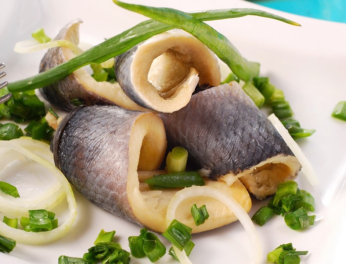 Rolled herring with onions and green onions