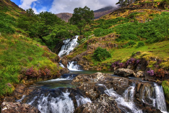 Waterfall in a green mountainous landscape in the UK