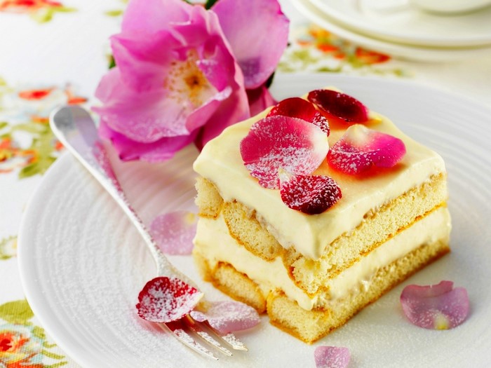 Tiramisu cake with rose petals and fork
