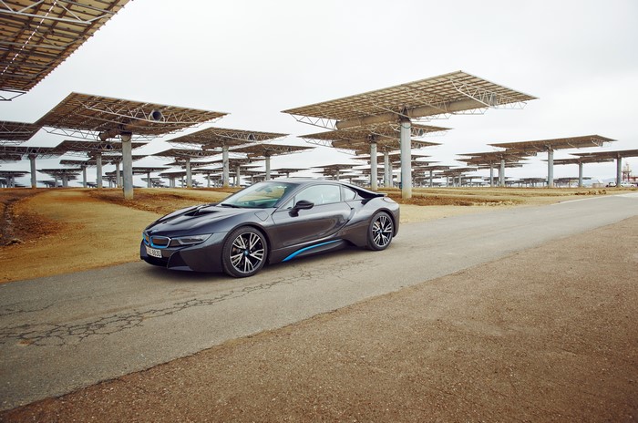 Grey 2015 BMW i8 parked near solar panels