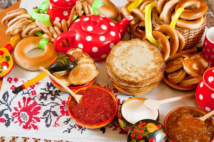 Russian Food Spread with Pancakes, Caviar, and Pastries