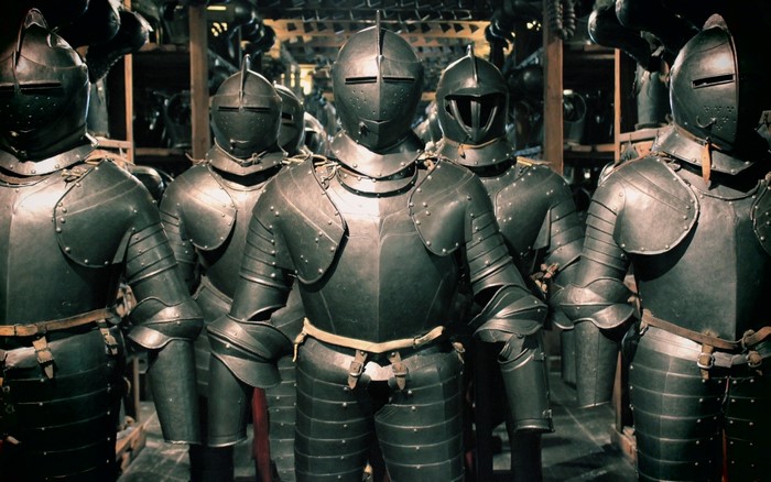Knights in full plate armor standing in a museum