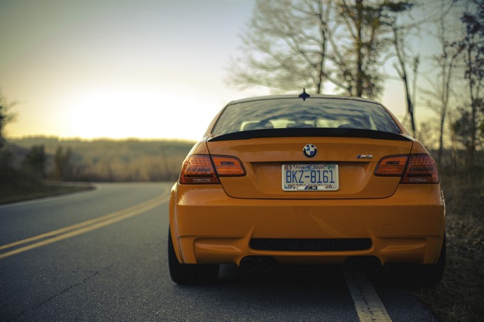 Orange BMW M3 on a Road