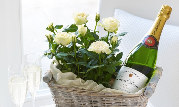 White Roses and Champagne in a Wicker Basket