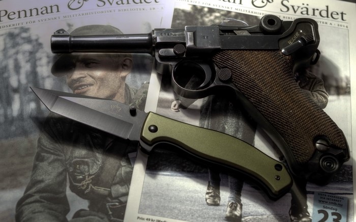 Luger pistol and knife on military magazine