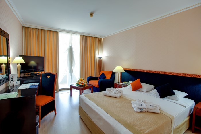 Hotel Bedroom Interior with Bed and Curtains