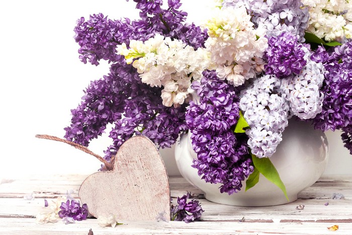 Lilacs in a vase with a wooden heart