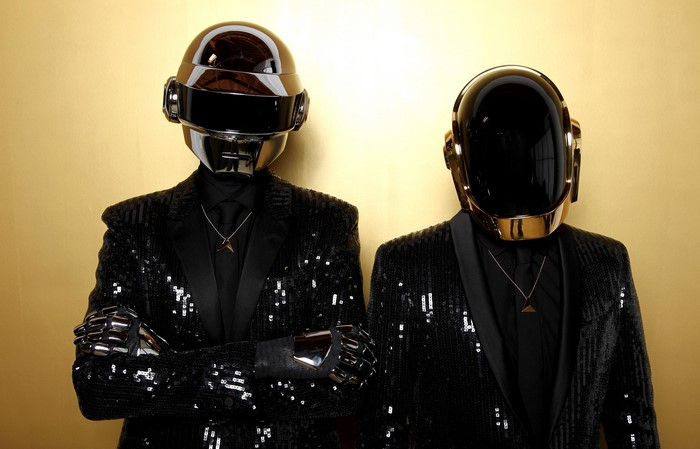 Daft Punk duo wearing helmets and sequined jackets