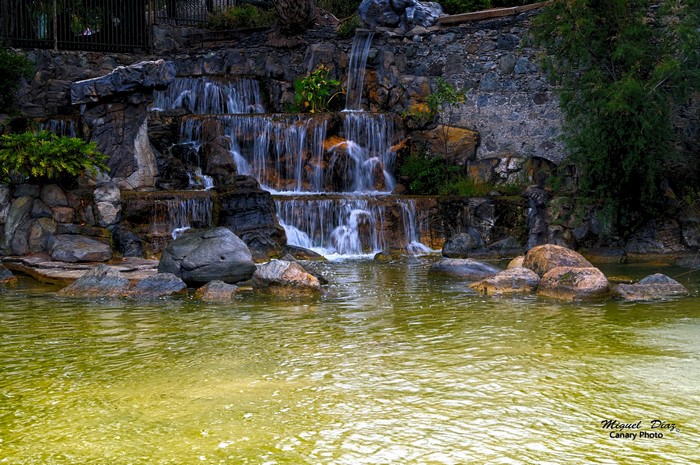 Waterfall cascading over rocks into a pond in the Canary Islands