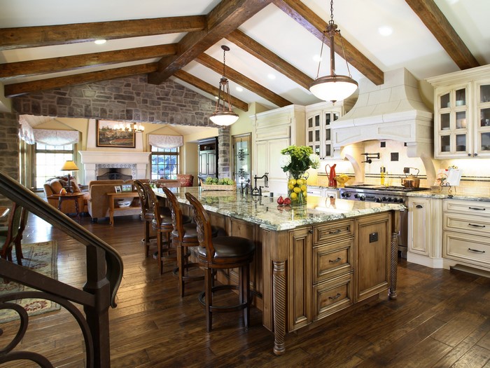 Luxury rustic kitchen and living room with island and fireplace