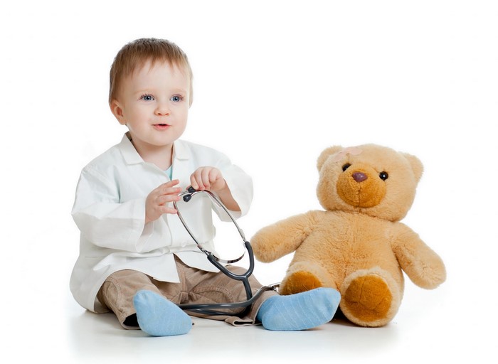 Baby dressed as doctor with teddy bear
