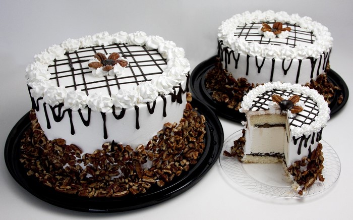 Three cakes with chocolate drizzle and pecans