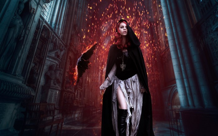 Woman in cloak with fiery crow in gothic cathedral