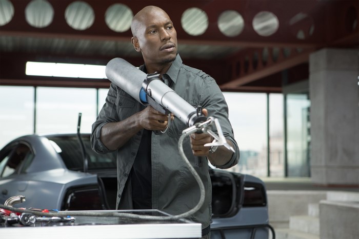 Roman Pearce from Fast & Furious 6 holding a device