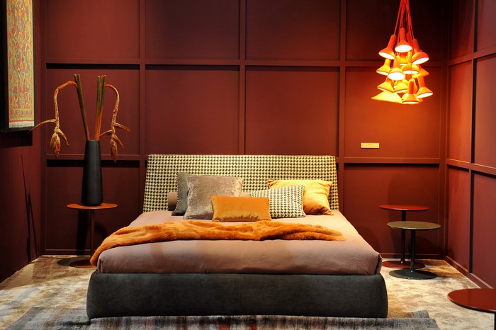 Bedroom with bed, pillows, and hanging lamp