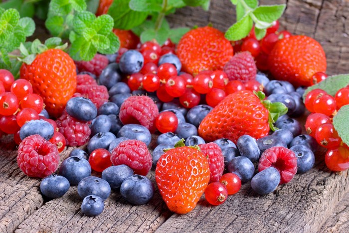 Strawberries, Raspberries, Blueberries, and Red Currants on Wood