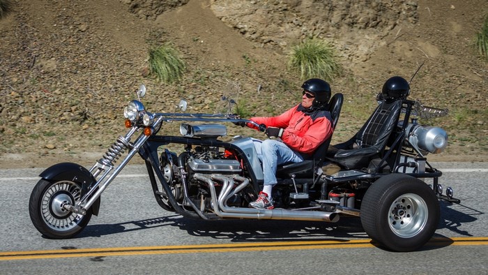 Man riding a V8 trike on a road