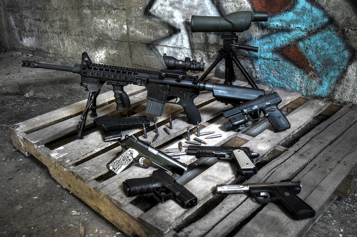 Collection of Firearms on Wooden Pallet