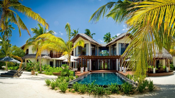 Luxury resort with pool and palm trees in Maldives