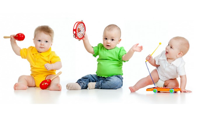 Three Babies Playing with Musical Toys