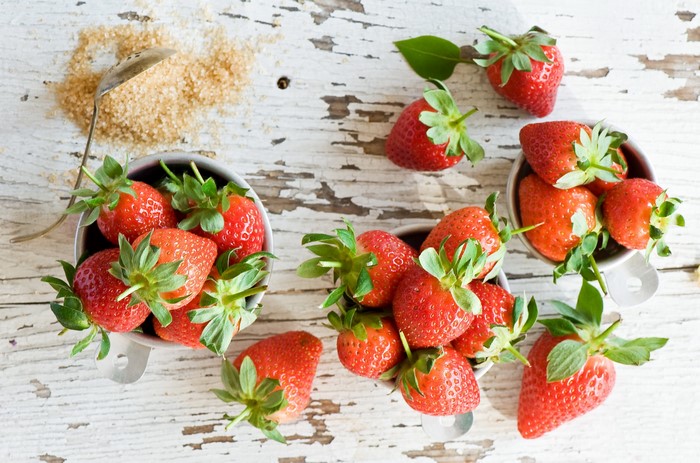 Strawberries and brown sugar on a wooden table