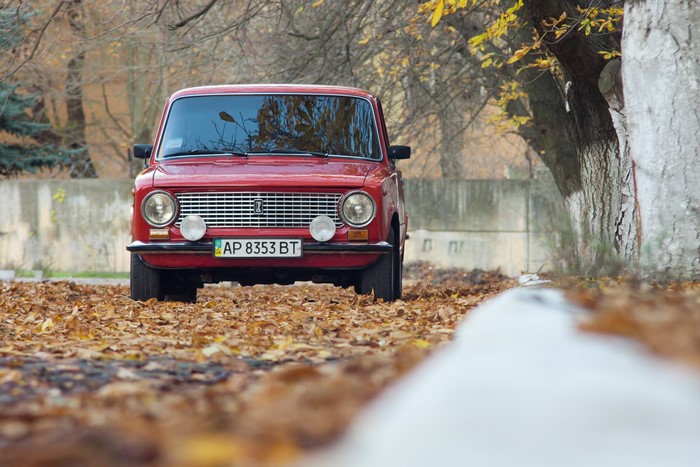 Red VAZ-2101 car in autumn foliage