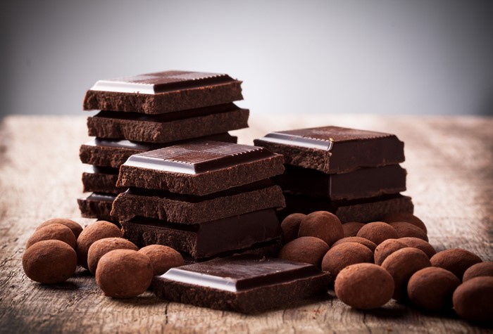 Chocolate bars and truffles on a wooden surface