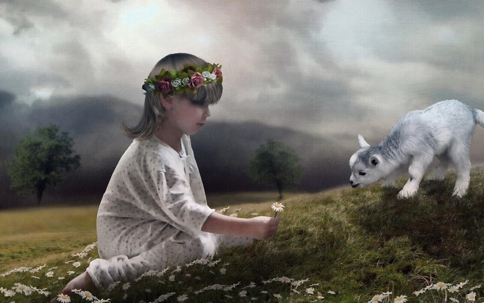 Girl with flower crown and goat in field