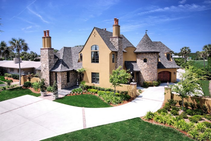 Luxury mansion with stone accents and turrets
