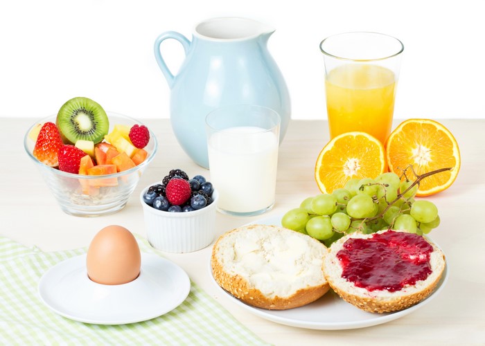 Breakfast with fruit, juice, milk, and egg