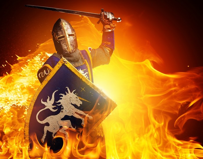 Knight in armor holding sword and shield in fire