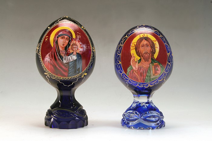 Two religious glass eggs with icons of Mary and Jesus